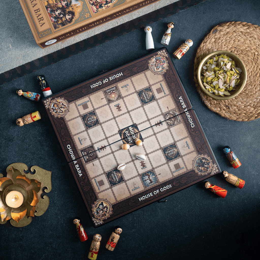 Chowka Bara cross-shaped game board showing four deity houses for Vishnu, Brahma, Shiva, and Ram with Moksha Point center